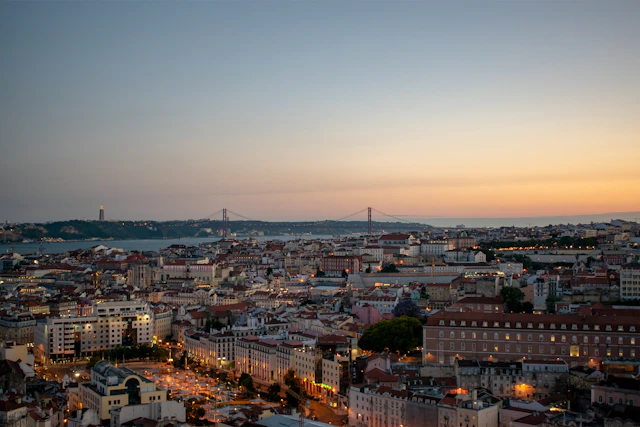 Lisbon rooftops and the Tagus River at dusk in Portugal
