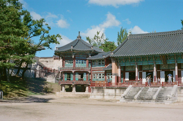 Traditional palace buildings beneath a blue sky in Seoul, South Korea